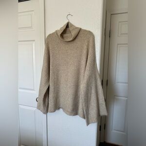Cream colored sweater with flared sleeves
